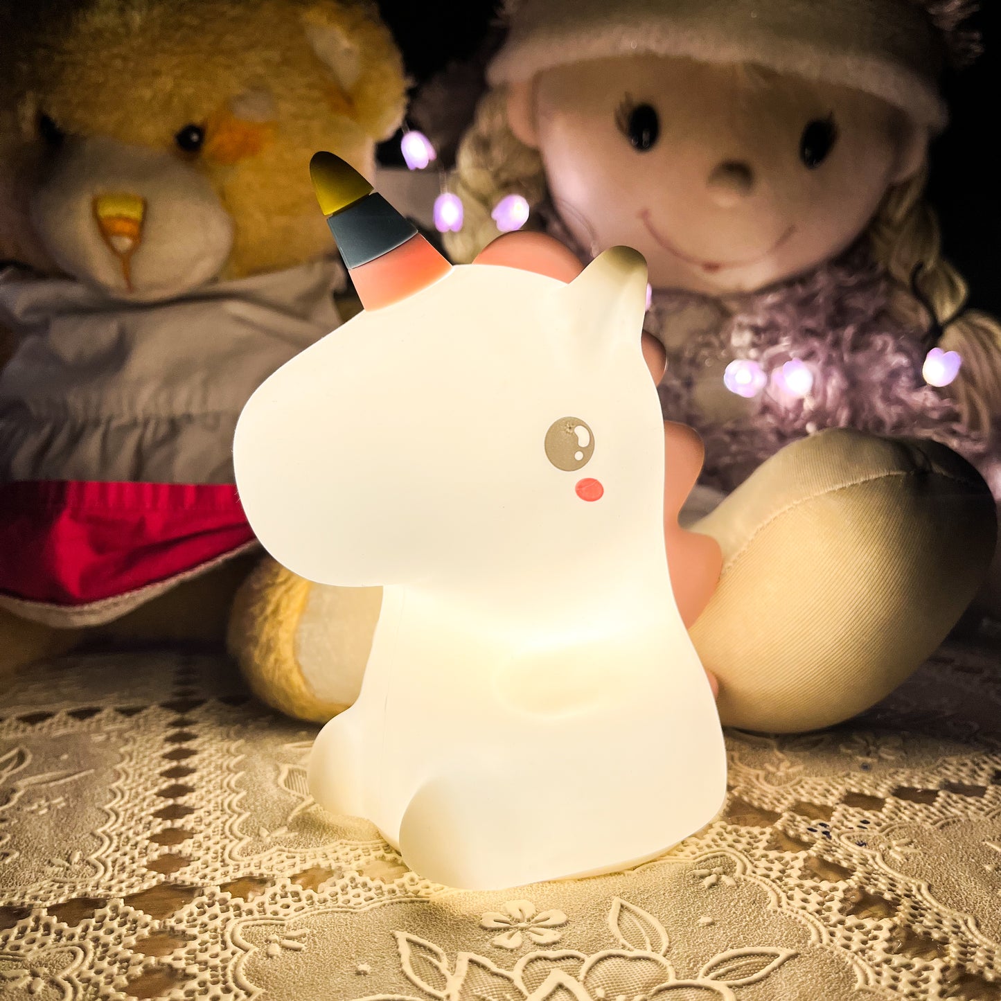 Cute animal-shaped night light with plush toys in the background